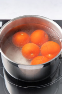 one pot of boiling water with tomatoes