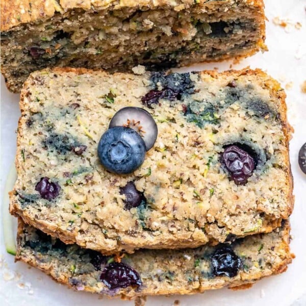 two slices of blueberry zucchini bread stacked over each other.