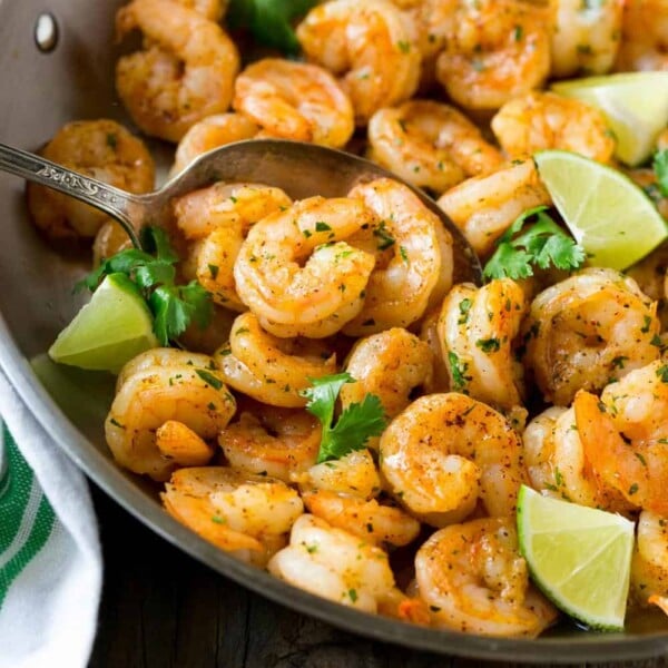 seared shrimp in a pan with lime and cilantro.