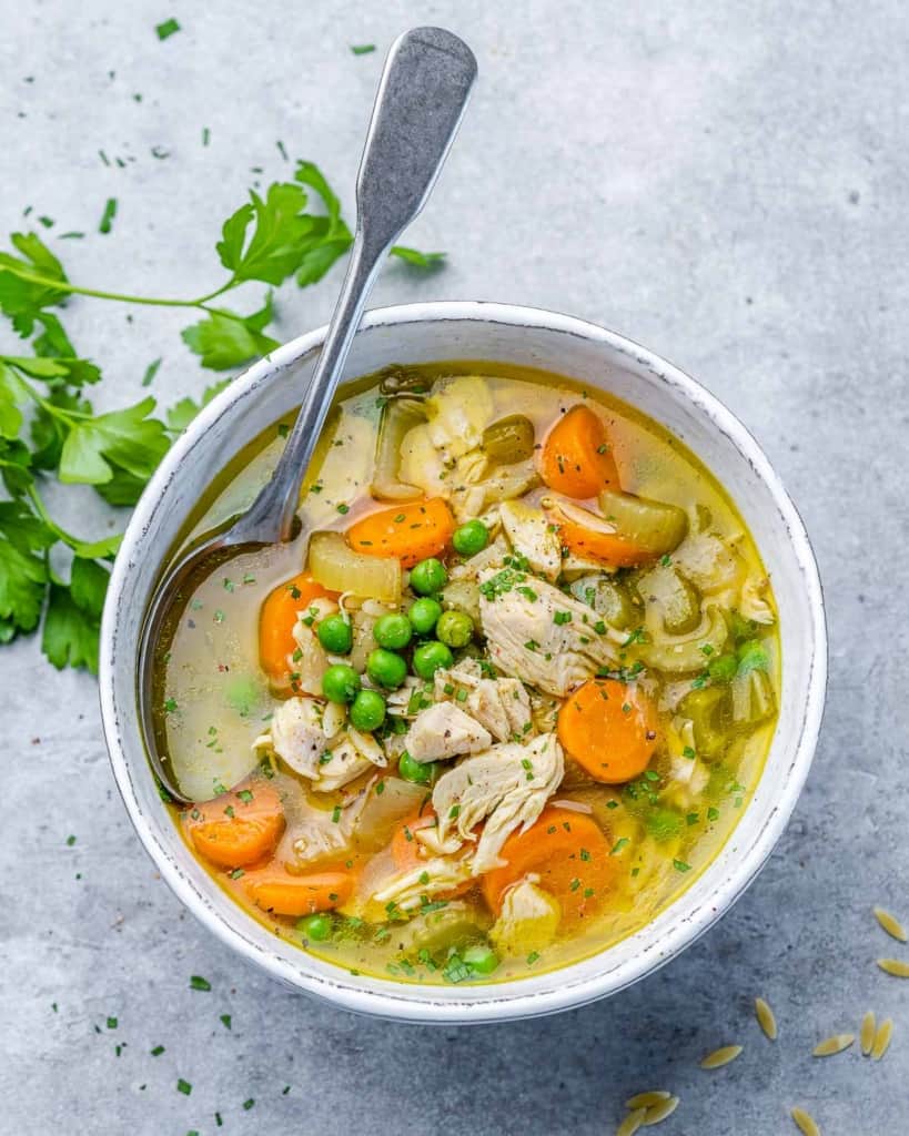 Soup in a white bowl served with a spoon.