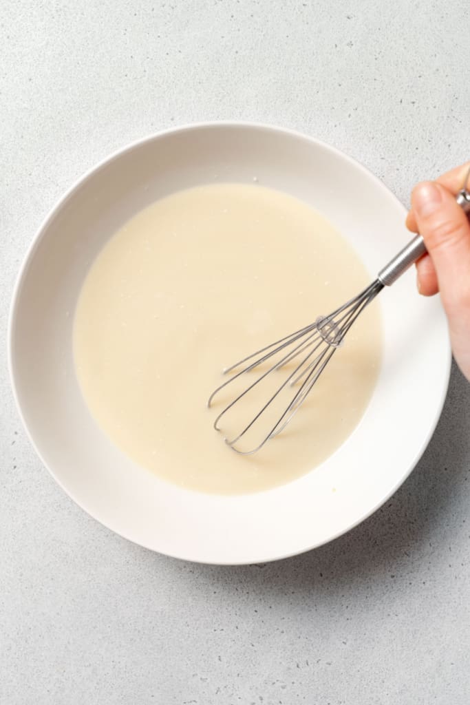 whisk mixing the milk