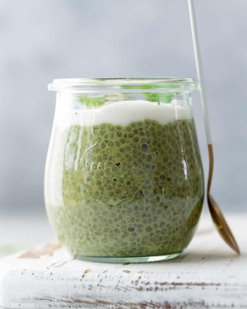 side shot of a jar with chia pudding topped with coconut whip or yogurt