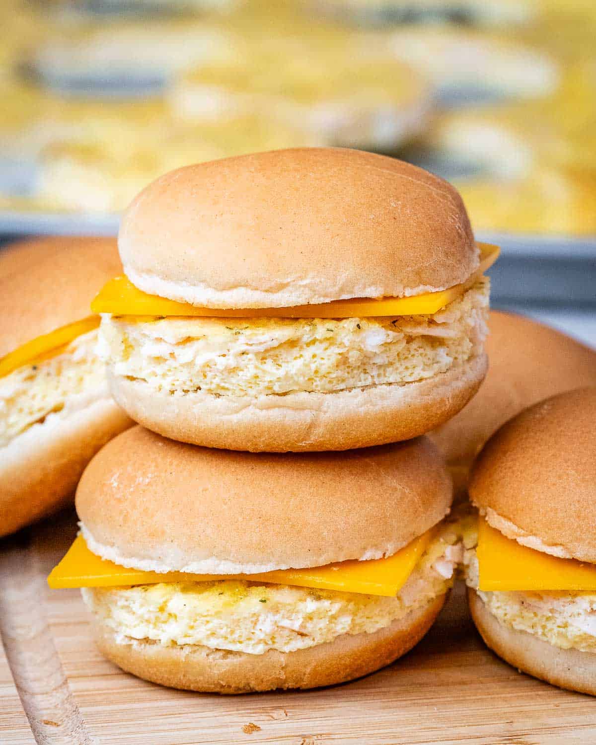 Five sandwiches with cheese with one on top of another.