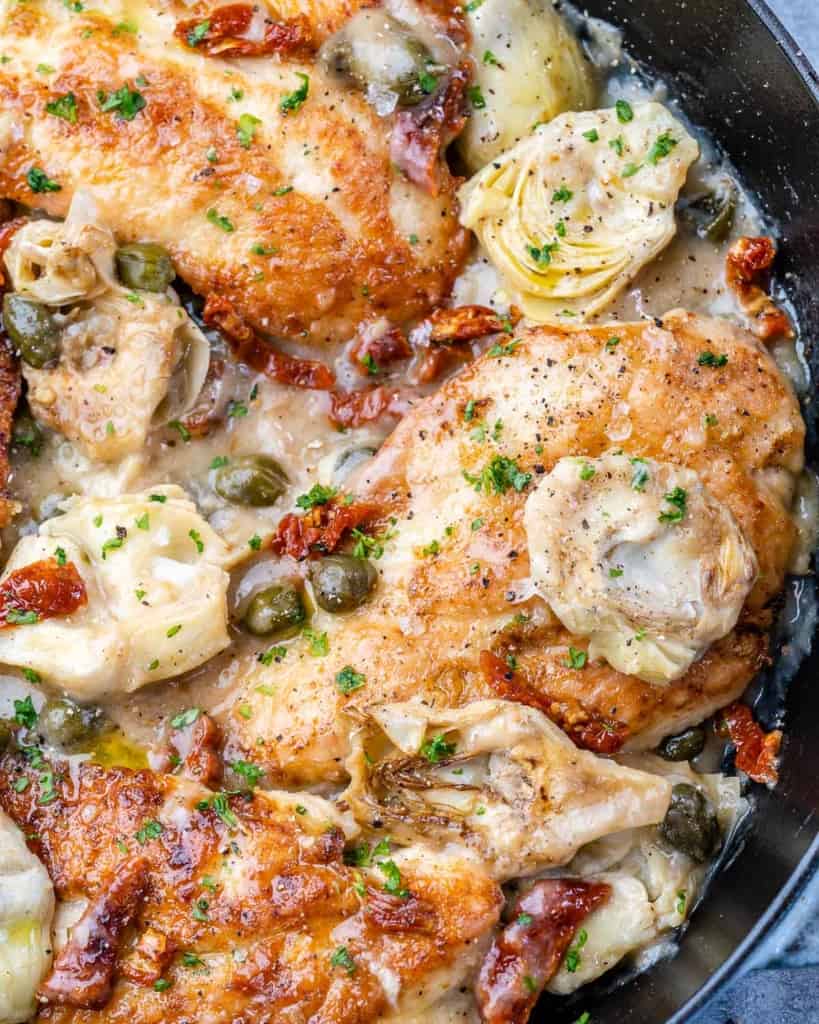 close up Mediterranean chicken in a black skillt