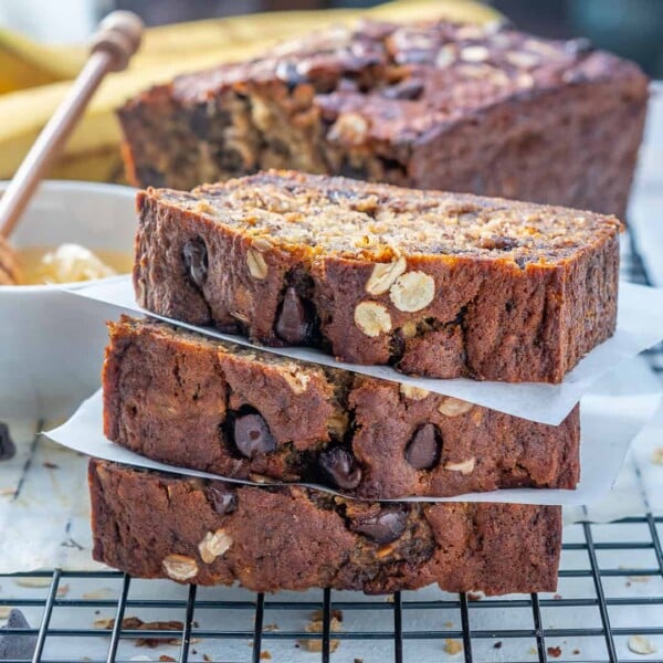 3 slices of Chocolate Chip Banana Bread stacked over each other on a wire wrack.