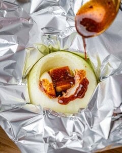 Seasoned oil is drizzled over the onion.