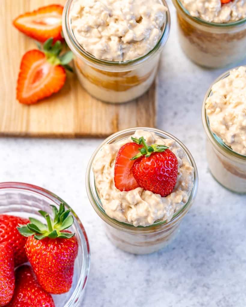 top view overnight oats in mason jars with strawberries 
