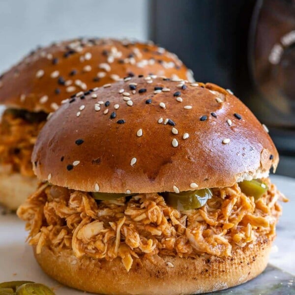 pulled chicken burger on a plate.