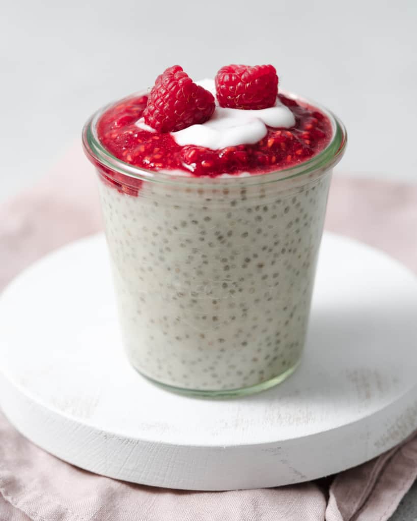 Layering raspberries on chia pudding.