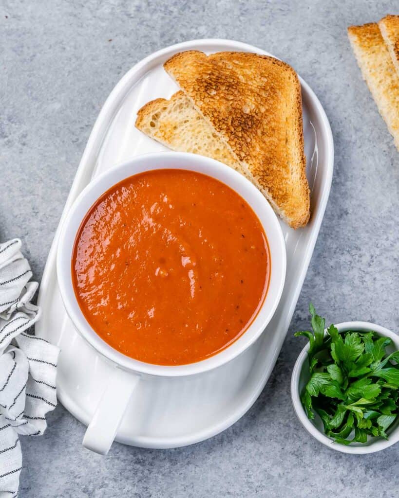 Soup served in a white bowl with a side of toasted bread.