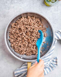 Browning beef in a skillet.