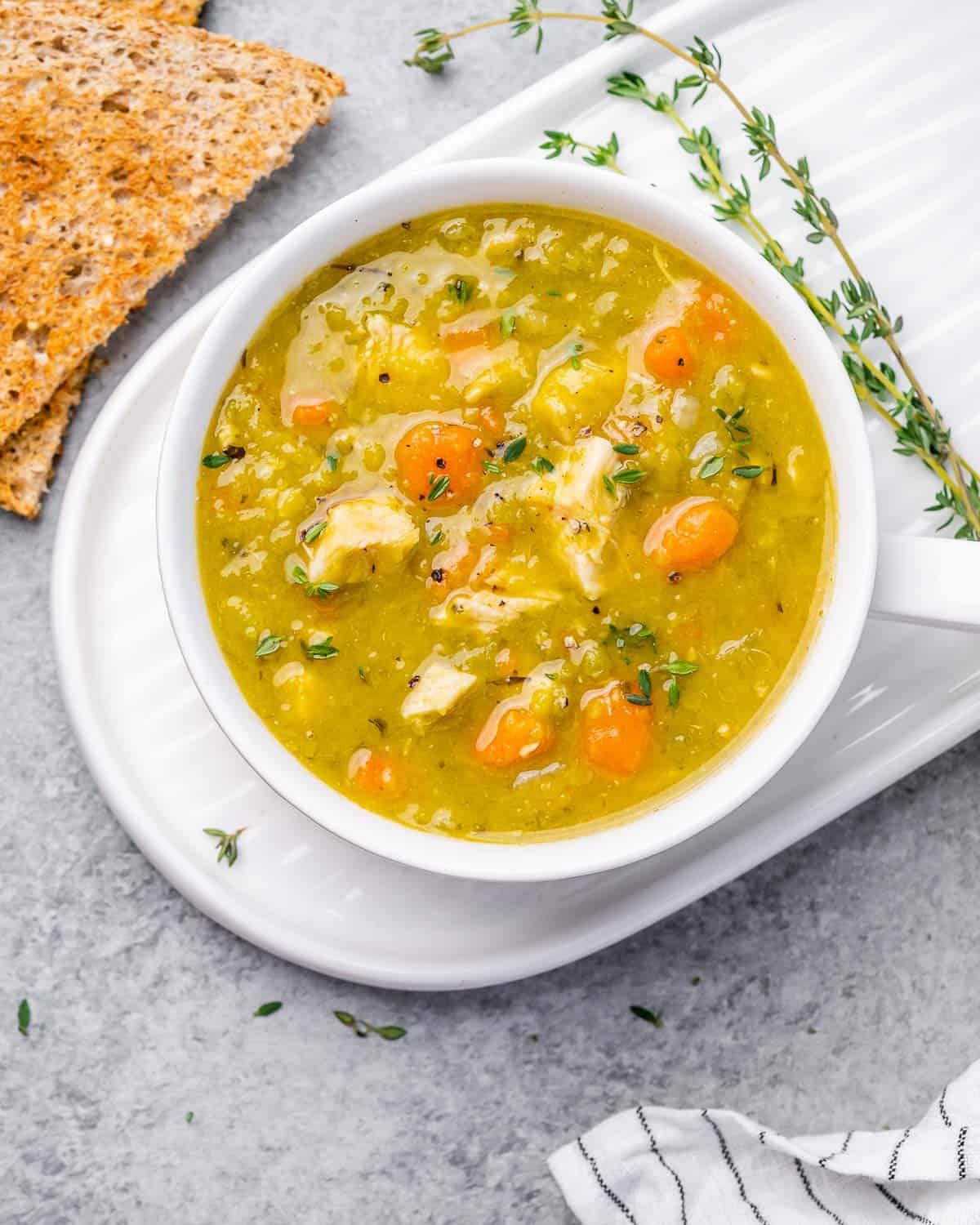 Top view of a white round bowl of split pea soup.