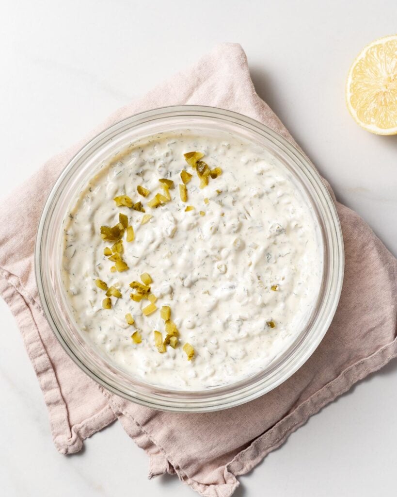 top view of tartar sauce in a bowl with pickle relish garnish