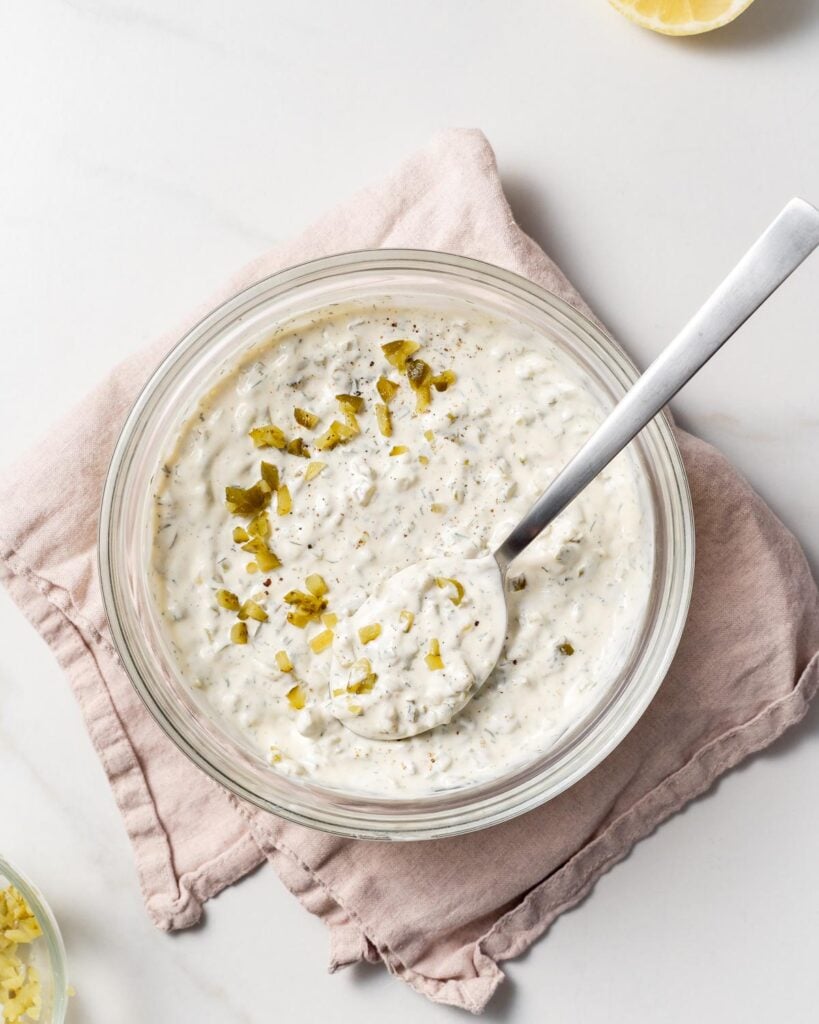 top view of a jar of tartar sauce with spoon in it