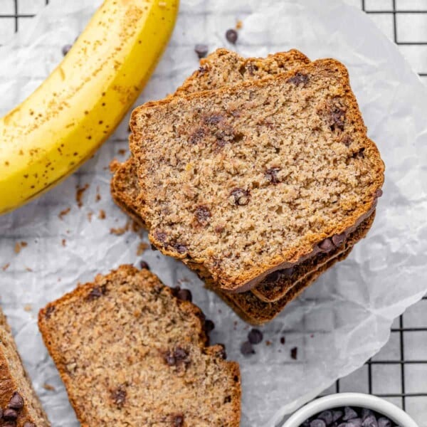 top view sliced banana bread stacks with a side of banana