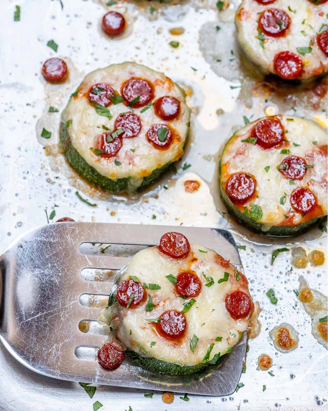 spatula getting a cheesy pizza zucchini bite.