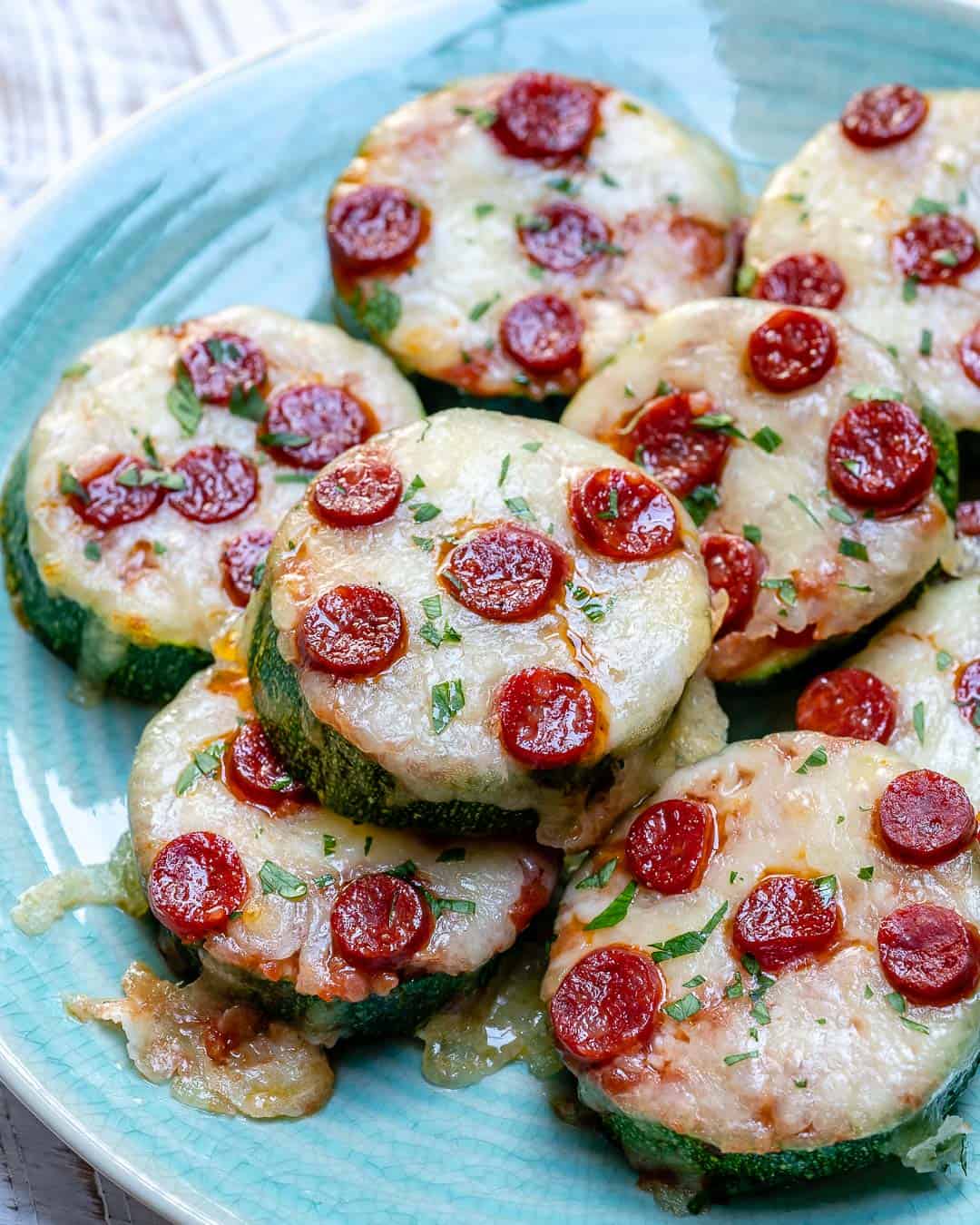 zucchini pizza bites slices topped with melted cheese and mini pepperoni.